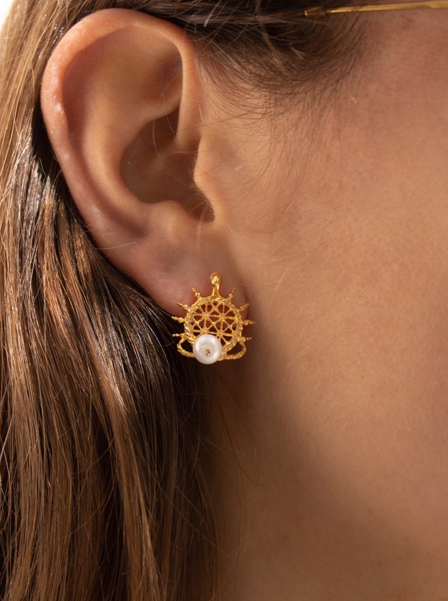 Pearl earring with a Hittite sun disk