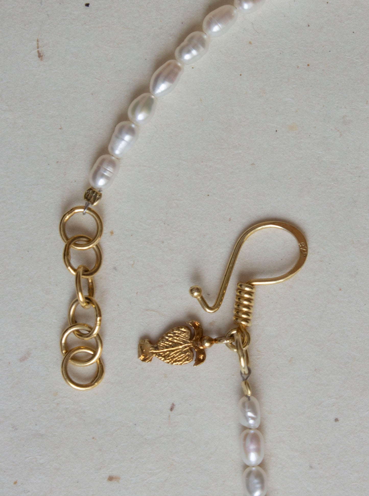 Roman hook closing details with pearls